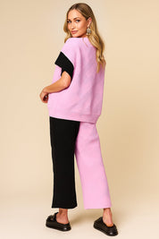 Back view of the pink and black colorblock textured top and wide-leg pants set showing overall knit texture.