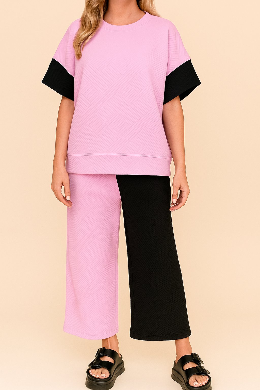 Straight front view of the pink and black colorblock textured top with matching wide-leg pants; relaxed fit.