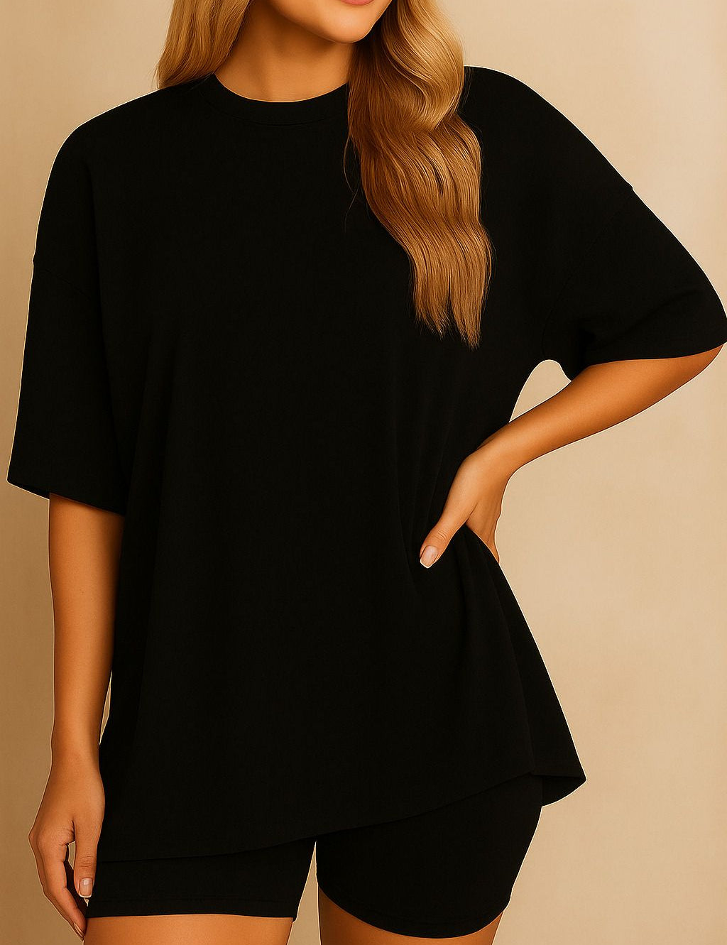 Plus size woman wearing an oversized black lounge set with round neck top and matching shorts