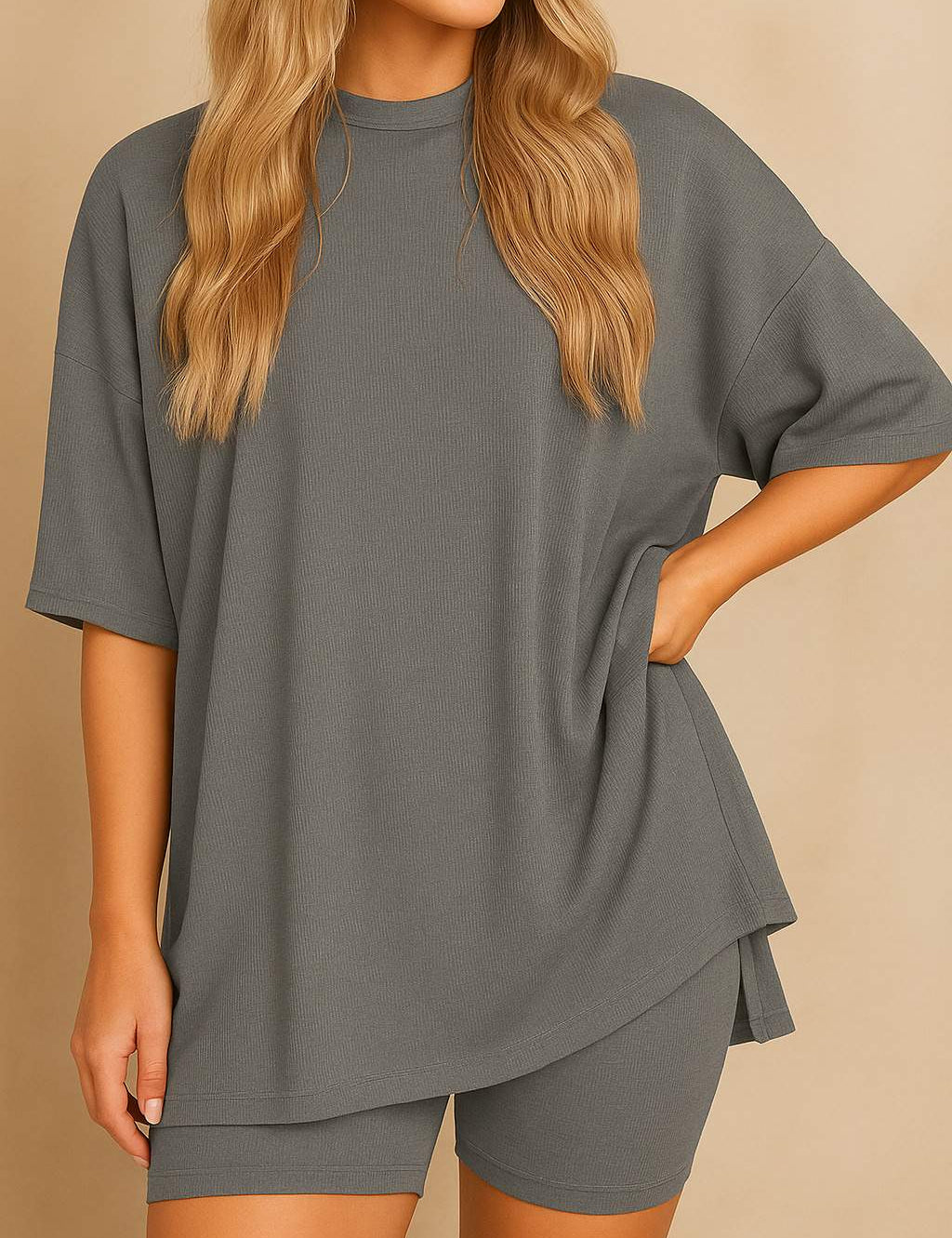 Plus size woman wearing an oversized grey lounge set with round neck top and matching shorts"