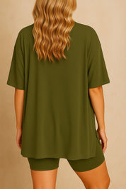 Back view of plus size woman wearing an oversized olive green lounge set with loose fit top and shorts
