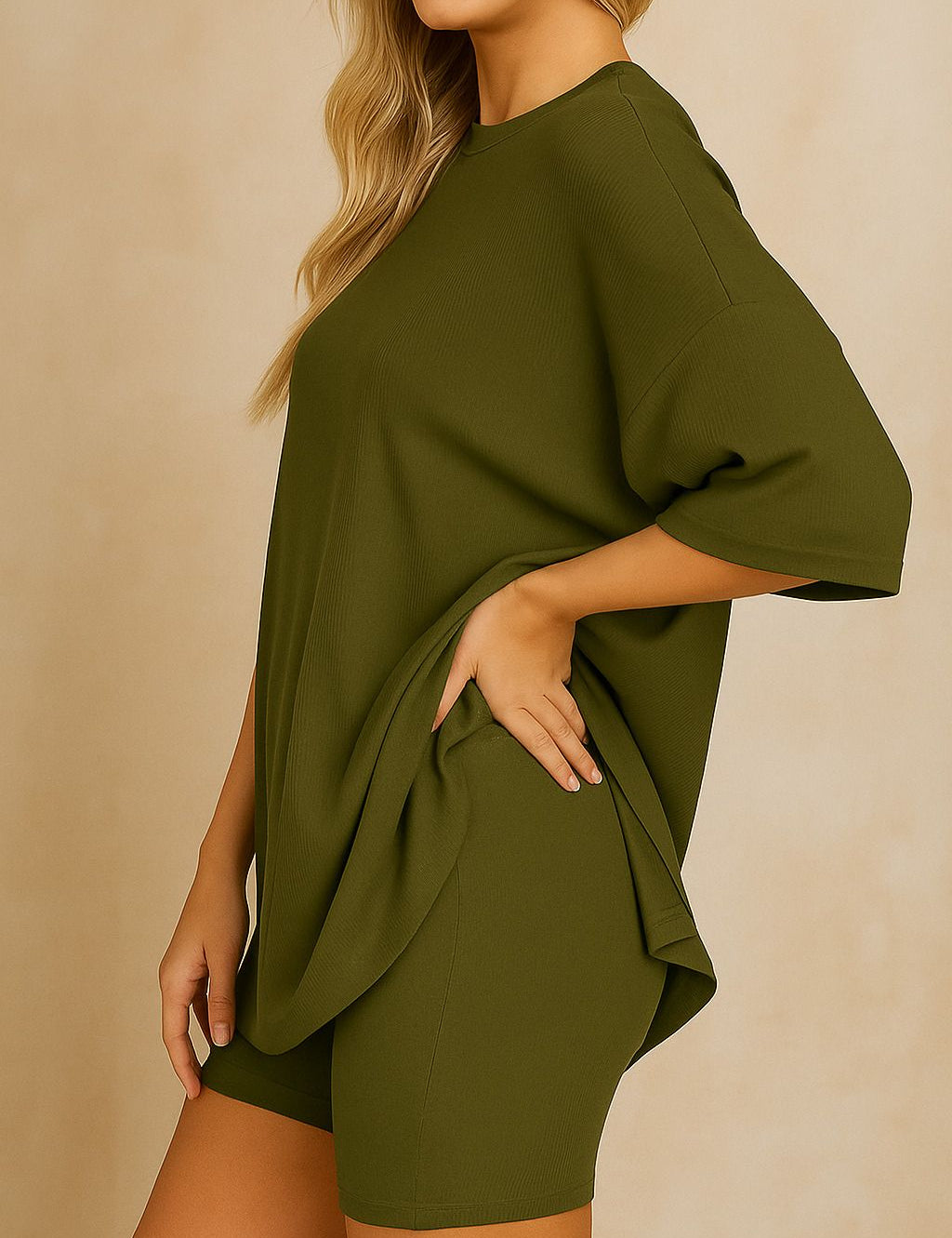 Side view of plus size woman wearing an oversized olive green lounge set with relaxed fit top and matching shorts