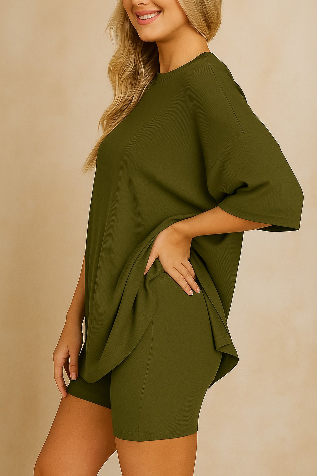 Side view of plus size woman wearing an oversized olive green lounge set with relaxed fit top and matching shorts