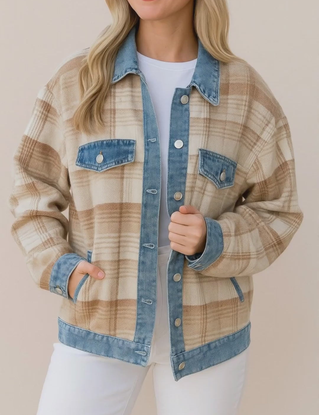 Short studio video of the plaid shacket with denim collar, placket, cuffs and hem, shown on a model without additional props.