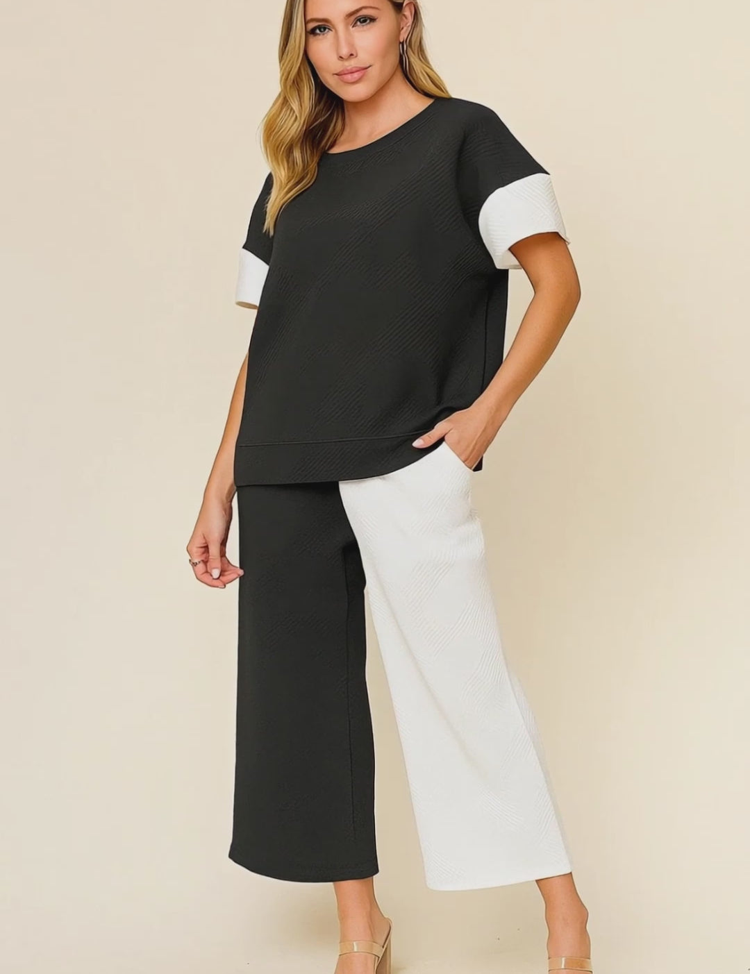 Short studio lookbook video of a black and white colorblock textured top with matching wide-leg pants and elastic waist.