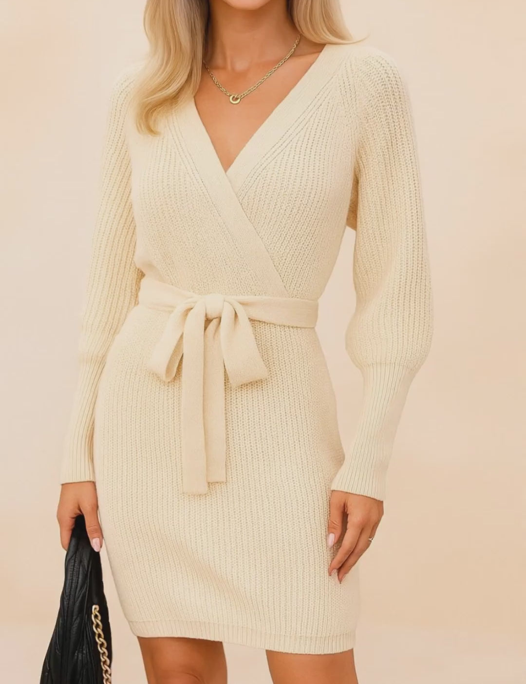 Short lookbook video showcasing a women’s ribbed-knit wrap sweater dress with a cross-over V-neck, long sleeves and a self-tie waist, shown from front and back in clean studio lighting.