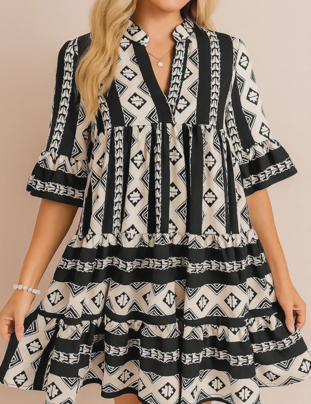 Black-and-white boho geometric tiered mini dress with notched neckline and flared half sleeves — studio lookbook video