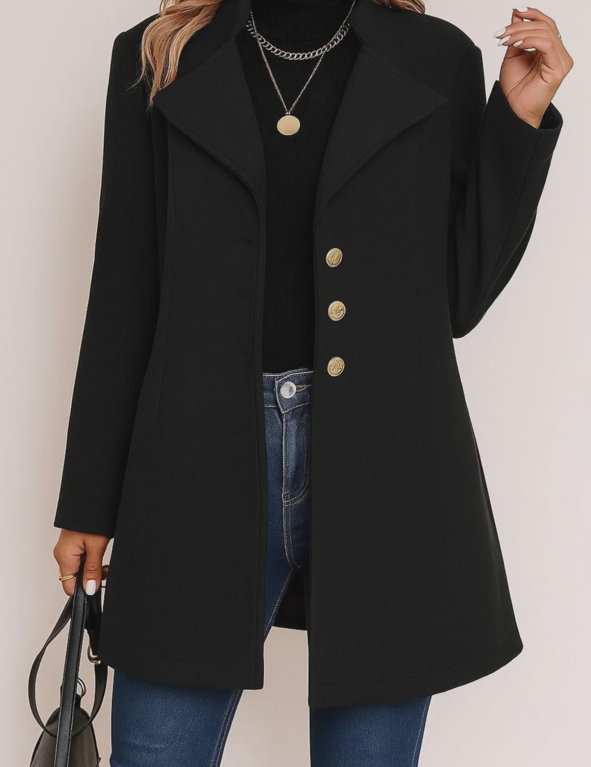 Short lookbook video showing the black tailored button-up coat with notched lapel, gold-tone buttons and straight hem from front and back views.