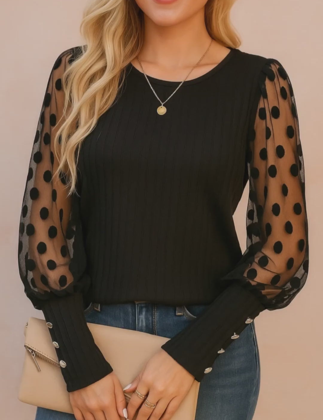 Black rib-knit blouse with sheer polka-dot mesh sleeves, button cuffs and round neckline — studio lookbook video.