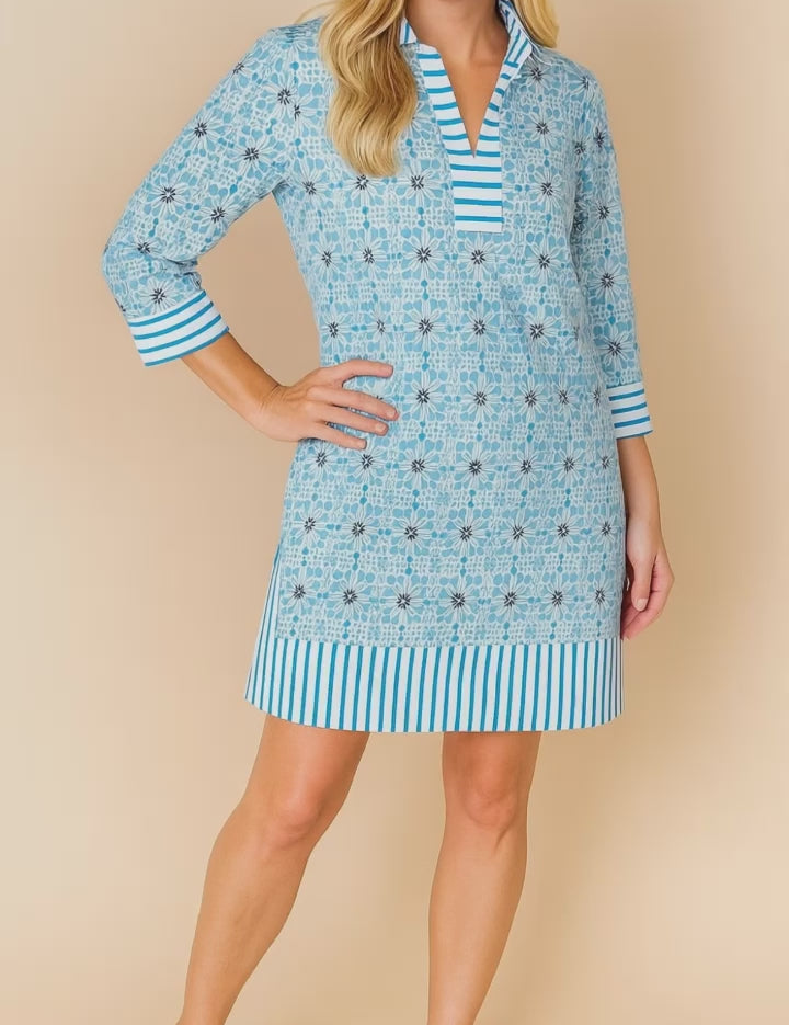 Pastel-blue floral tunic dress with split V-neck and striped trim at collar, cuffs and hem, three-quarter sleeves — studio lookbook video.