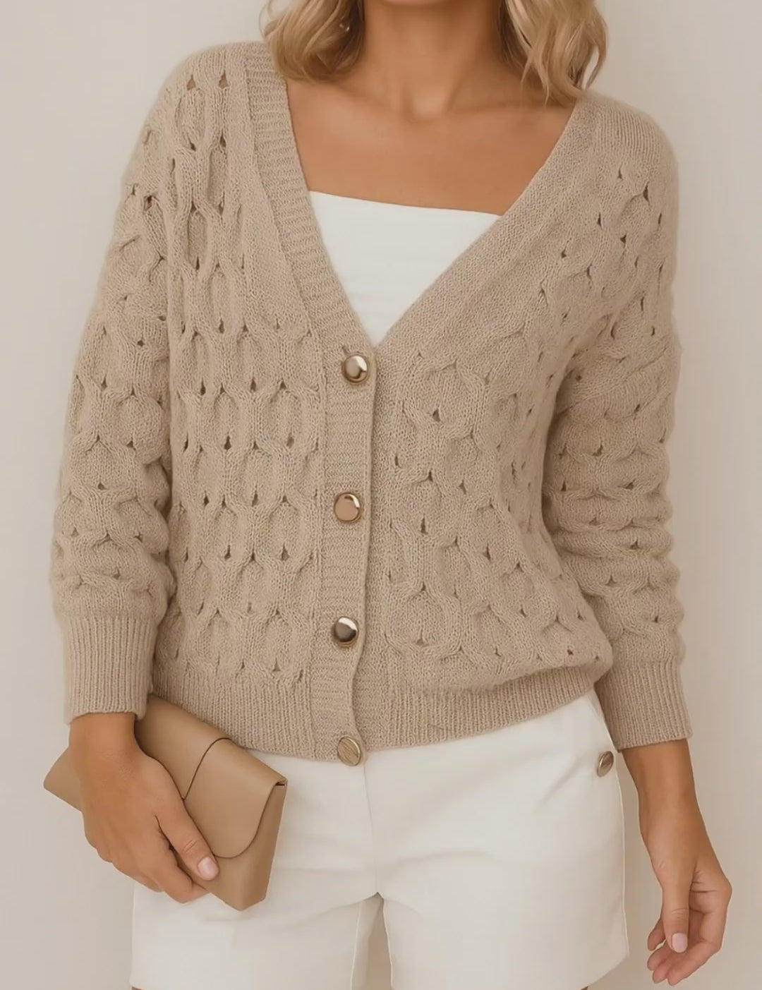Short lookbook video of a khaki textured V-neck cardigan showing the gold-tone button-front, soft balloon sleeves, and ribbed cuffs and hem in studio lighting.