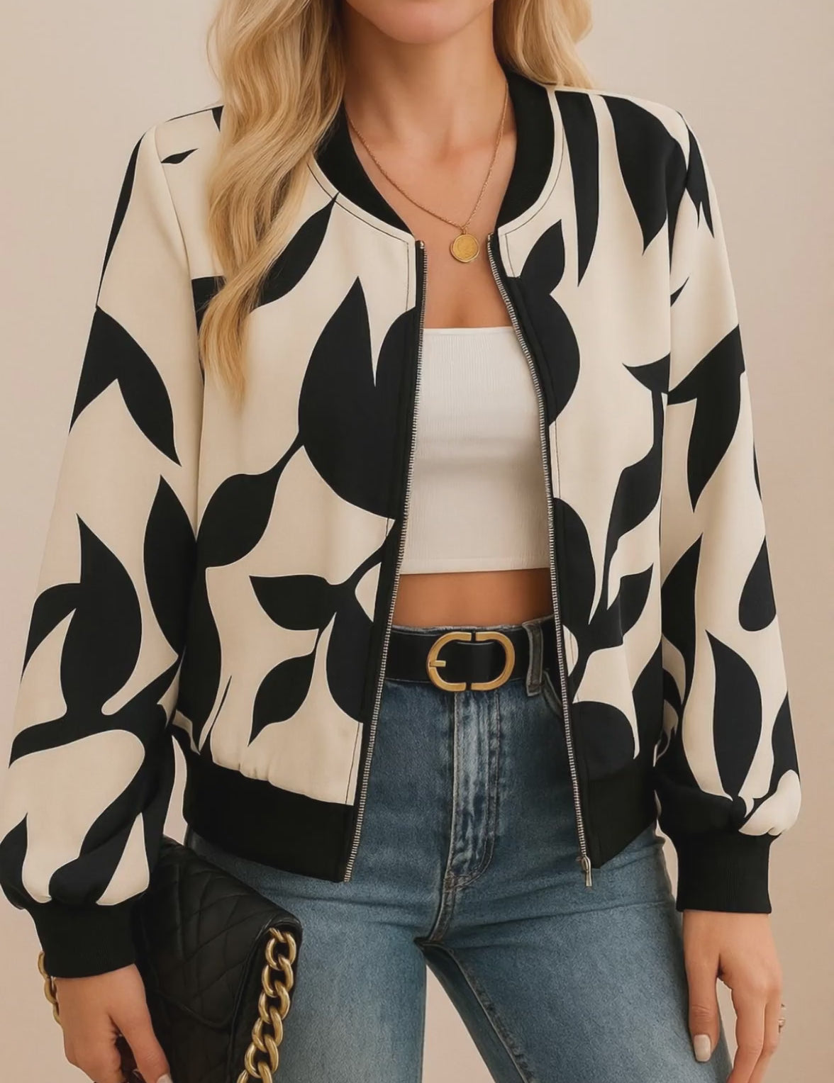 Short lookbook video showing a cream-and-black abstract-print zip-up bomber jacket with rib-knit collar, cuffs and hem from front and back views