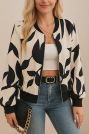 Short lookbook video showing a cream-and-black abstract-print zip-up bomber jacket with rib-knit collar, cuffs and hem from front and back views