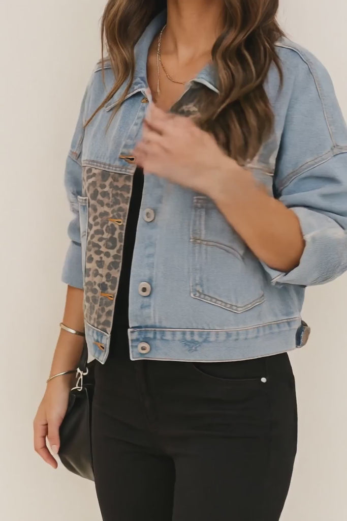 Short lookbook video of a light-wash denim jacket with leopard-panel inserts, button front, drop-shoulder fit and slant pockets, shown in studio.