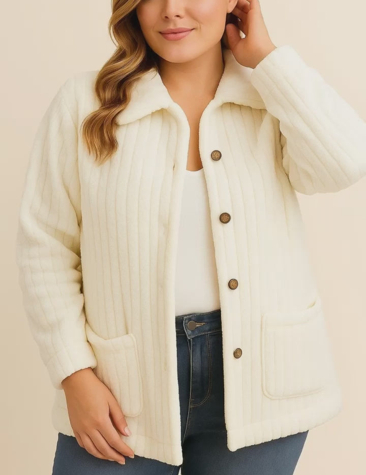 Short lookbook video of a white fuzzy collared button-down jacket with drop-shoulder sleeves and front patch pockets, shown in studio lighting.