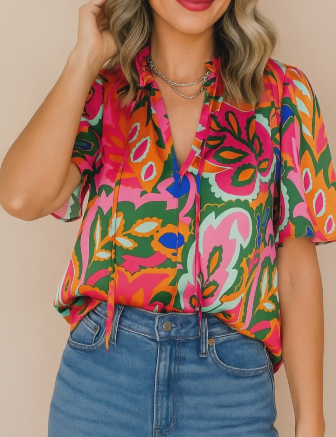 Short studio lookbook video of a rose-multi tropical print tie-neck short-sleeve blouse showing the neckline ties and relaxed drape