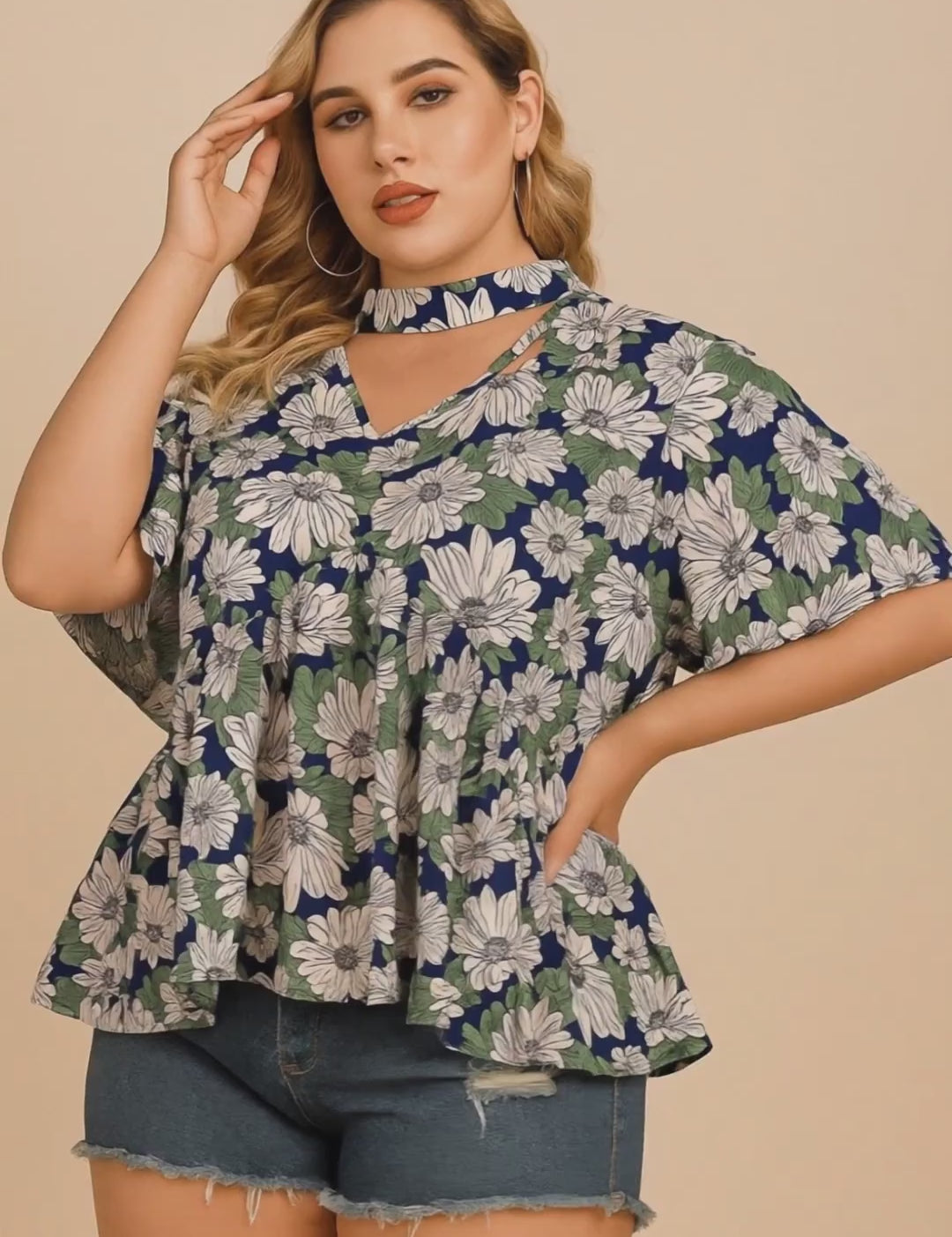Short studio lookbook video of a dark blue floral blouse featuring a cutout choker V-neckline and flutter sleeves, shown on-body.