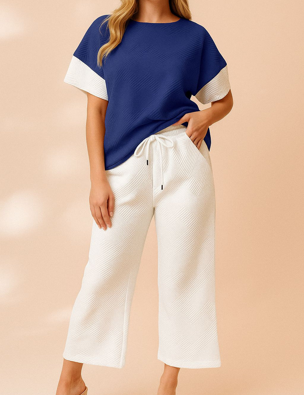 Front view of a royal-blue and white colorblock textured short-sleeve top with matching wide-leg pants and drawstring elastic waist