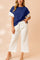 Front view of a royal-blue and white colorblock textured short-sleeve top with matching wide-leg pants and drawstring elastic waist