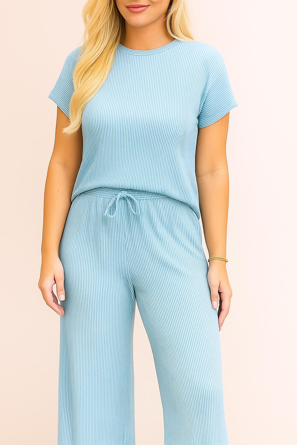 Front detail of the ribbed knit top and waistband, showing the round neckline, fine rib texture and the adjustable drawstring at the waist.