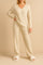 Women’s tan ribbed knit V-neck lounge set with long-sleeve sweater and straight-leg pull-on pants — front three-quarter view.