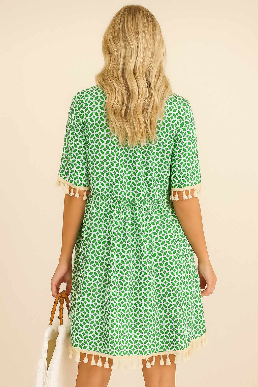 Turquoise geometric-print tassel-trim mini dress with gathered back waist and tassel hem — back view.