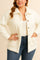 Front view of a women’s white fuzzy collared button-down jacket with drop-shoulder sleeves and front patch pockets; straight hem.