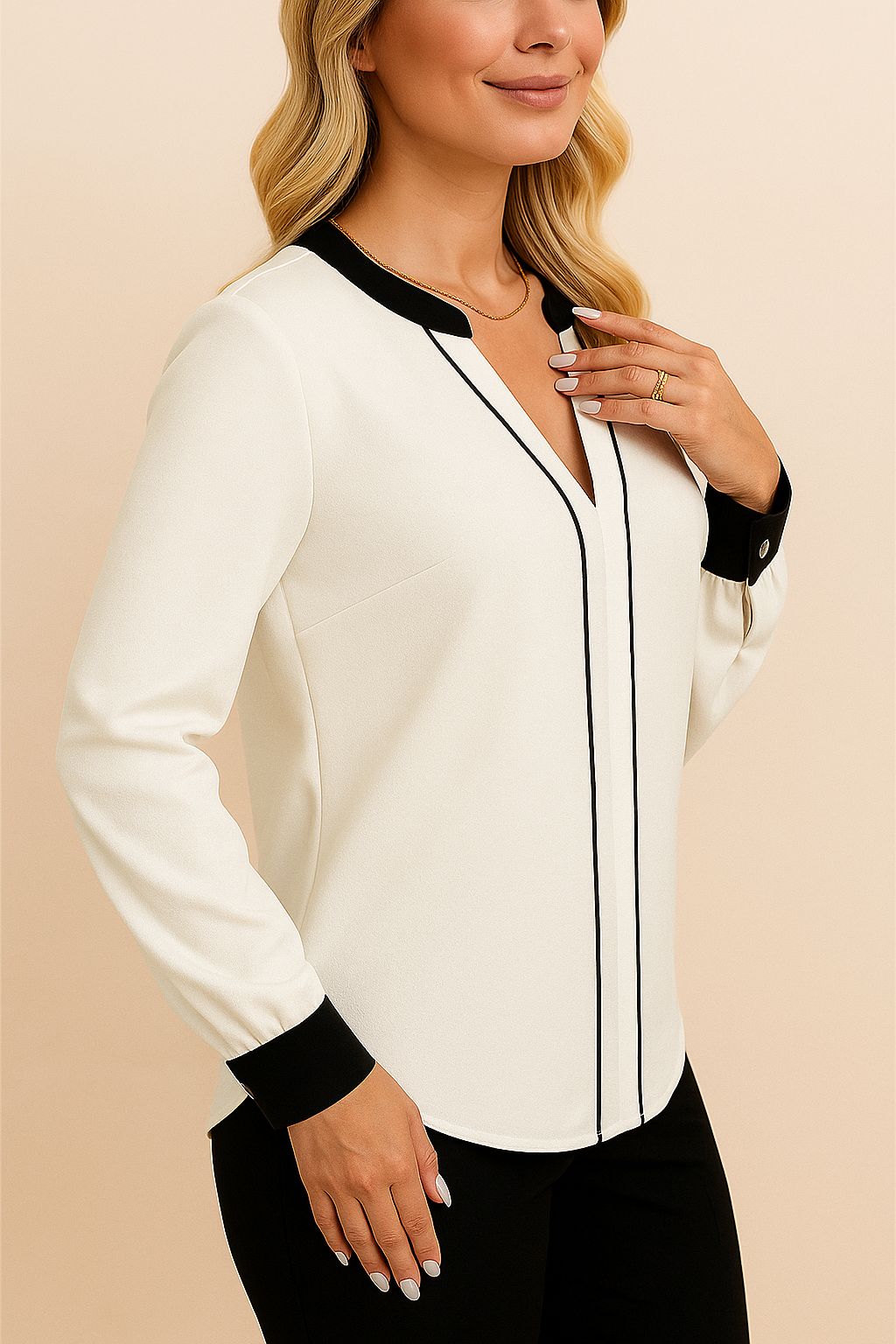 Right three-quarter view of the white blouse with black contrast trim at the neckline and cuffs; smooth drape