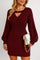 Front view of a women’s cable-knit sweater dress in wine featuring a V-neck cutout, long sleeves and a ribbed waistband that defines the waist